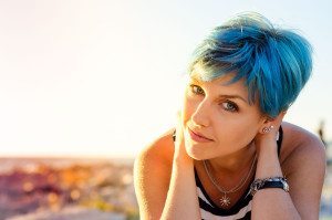 A portrait of beautiful girl with blue hair in sailor's striped top.
